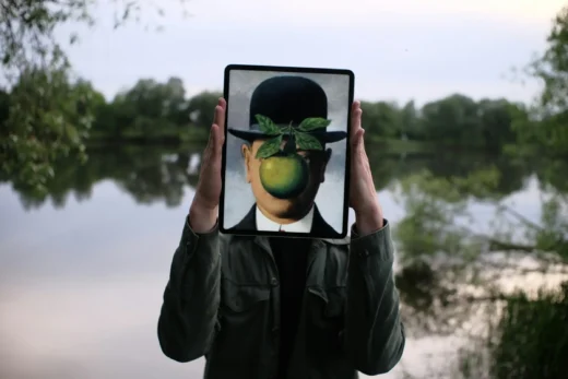 Pessoa segurando um tablet com um rosto alterado digitalmente, representando o que é deepfake e a manipulação da identidade por meio de inteligência artificial.